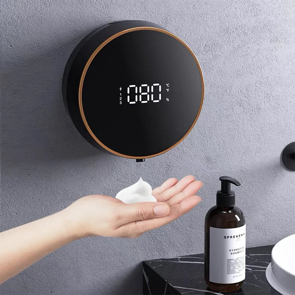 Automatic sensor foam soap dispenser in black mounted on a bathroom wall.