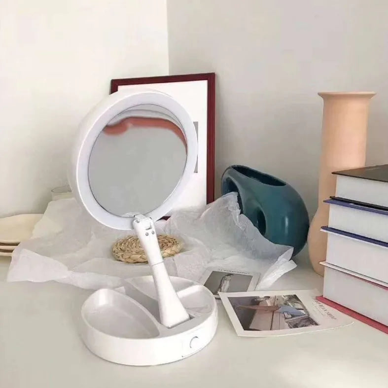 White foldable double-sided LED vanity mirror with built-in storage compartments and USB cable.