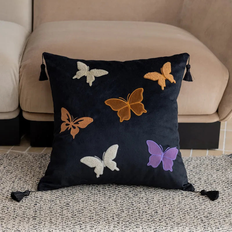 Square beige cushion with black butterfly embroidery in a Chinese style, 45cm by 45cm.