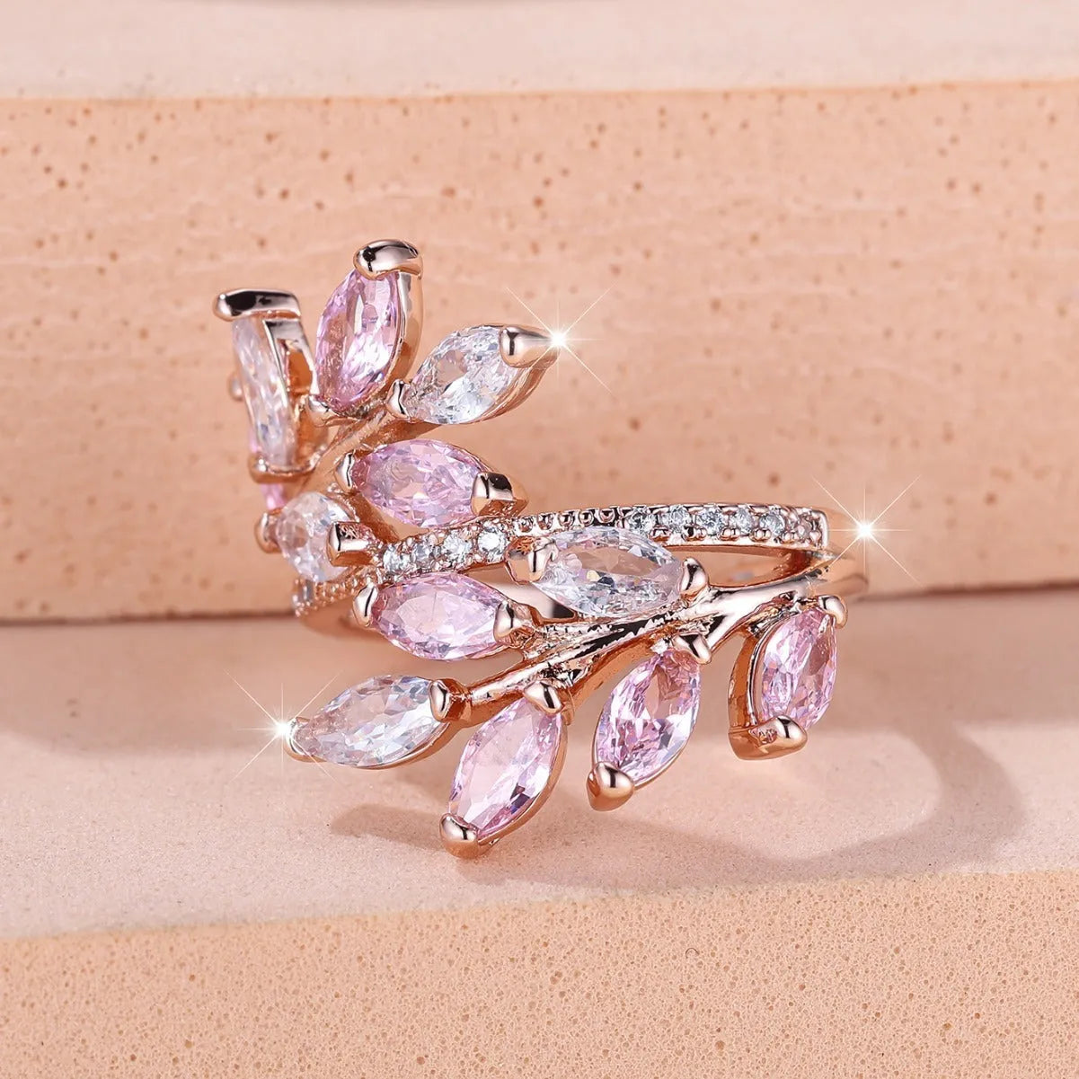 Adjustable copper leaf ring with zircon detailing in multiple colour options on display