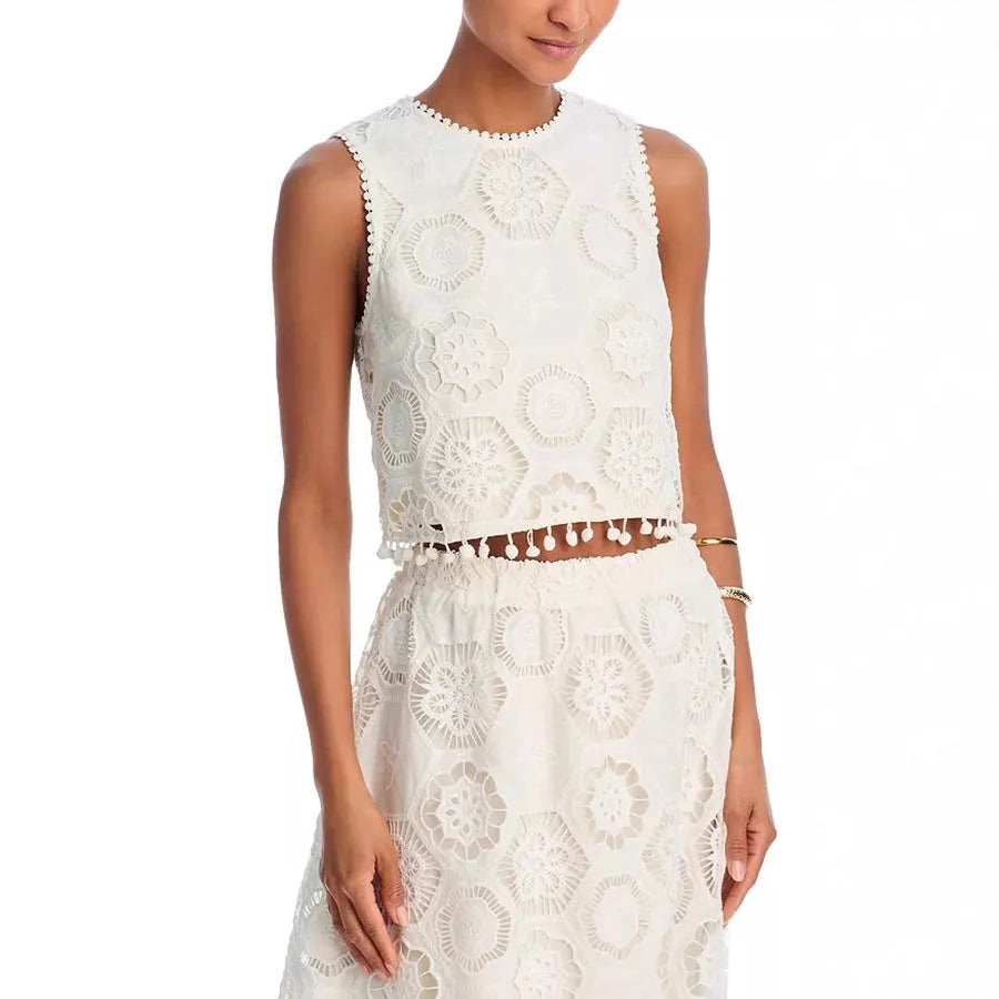 White women's sleeveless top and long skirt suit set with retro embroidery on a hanger