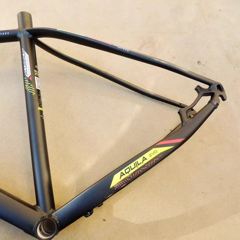 Black green aluminium 29-inch mountain bike frame with disc brake mounts and internal cable routing ports.