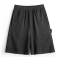 Cement grey American-style loose fit straight leg sports shorts made from heavy polyester fabric.