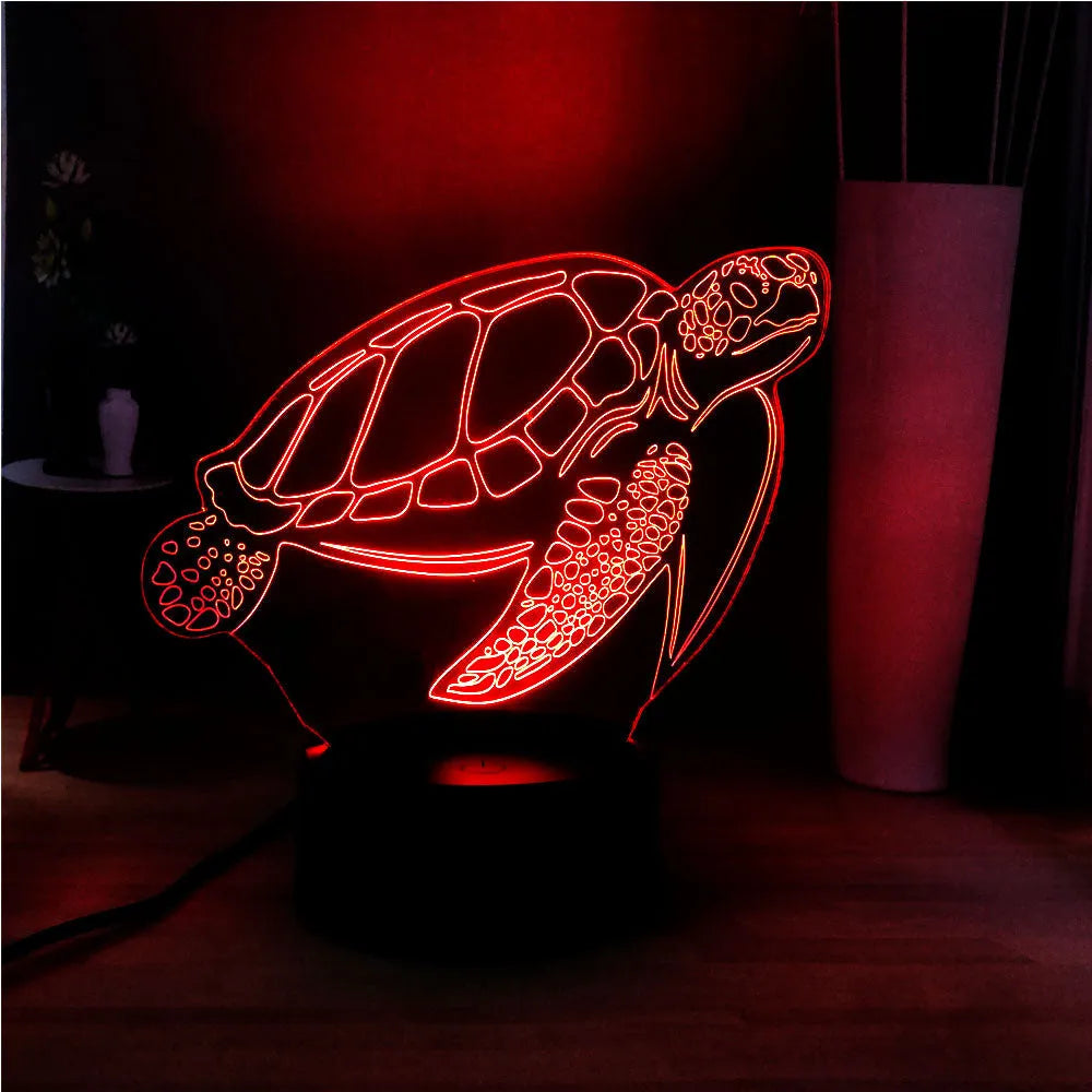 3D clear acrylic turtle-shaped LED night light with multi-colour glow on a surface.