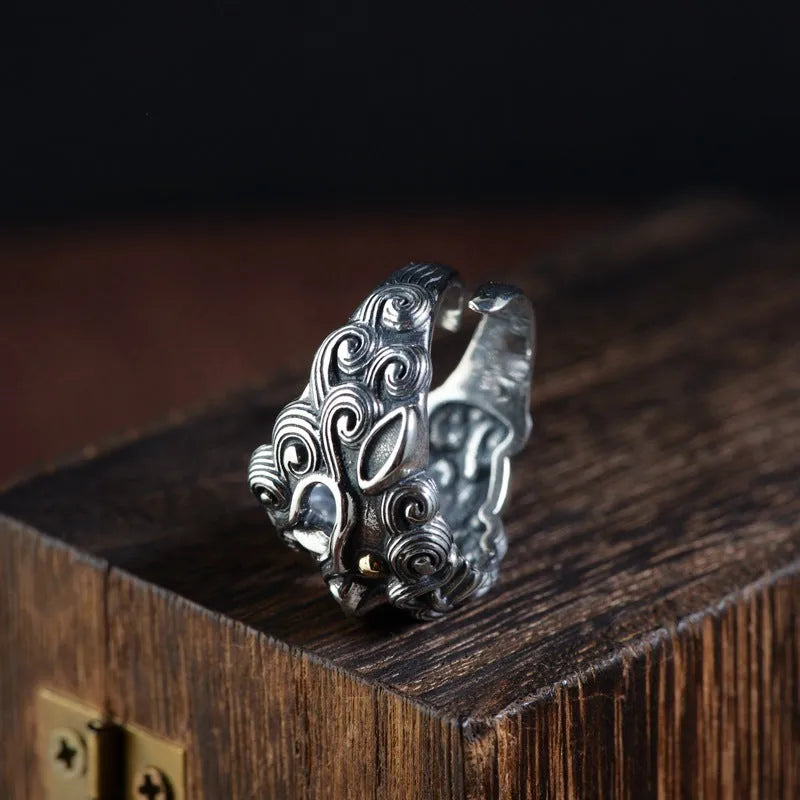 Silver open ring with domineering jibeast pattern showing animal zodiac modelling details