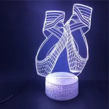 3D ballet shoes night light with colourful LED glow, showing remote control and USB cable.