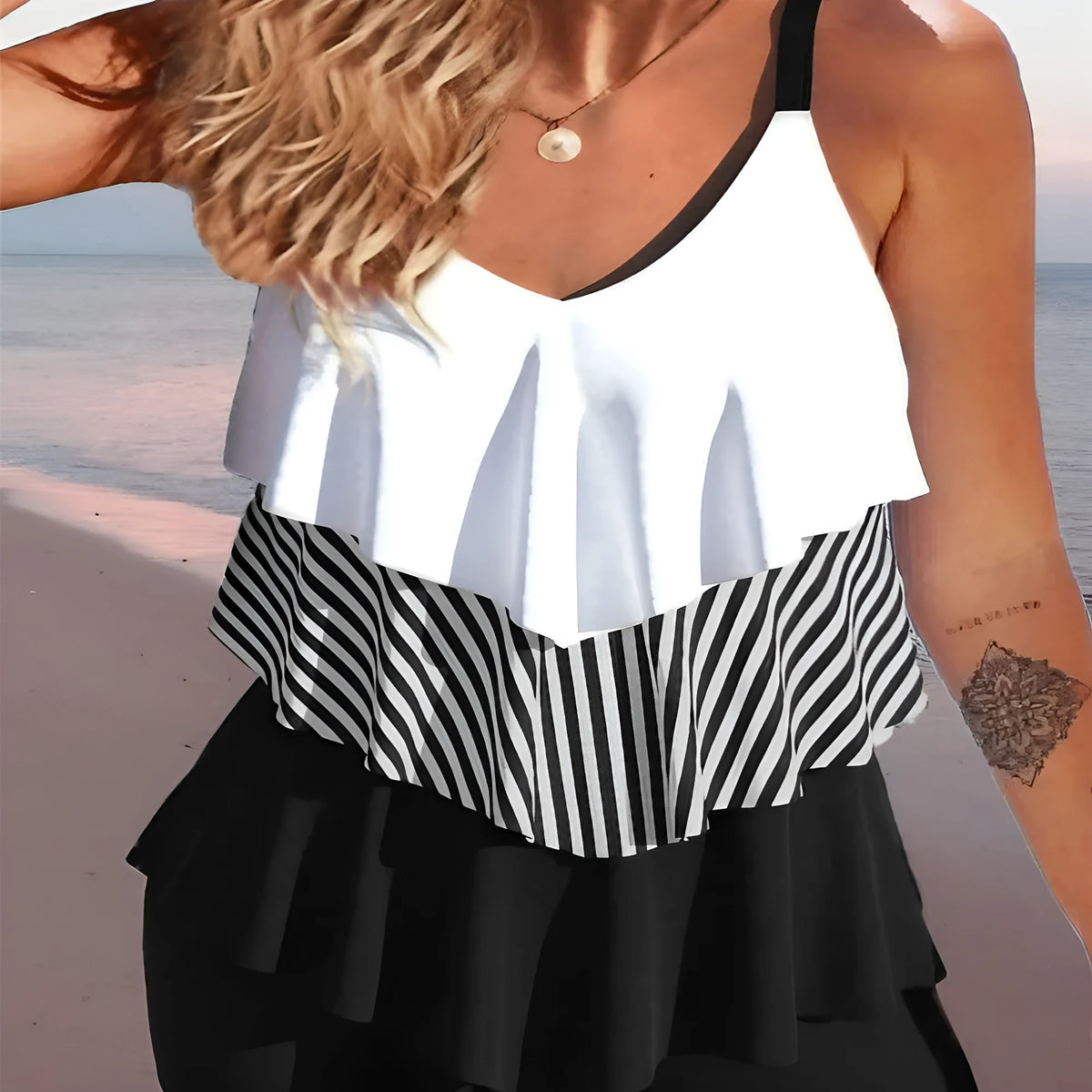 Women's sleeveless backless bikini swimsuit with ruffle detail and brief shorts.
