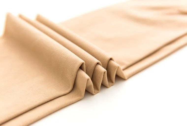 Beige and black lifting stovepipe socks for tummy control and hip shaping, one size fits 40-67.5kg.