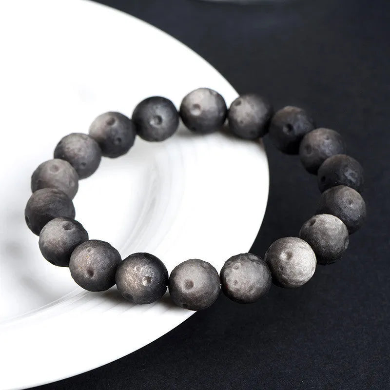 Natural obsidian crater ball bracelet with grinding finish in silver or golden meteorite colours with various bead sizes