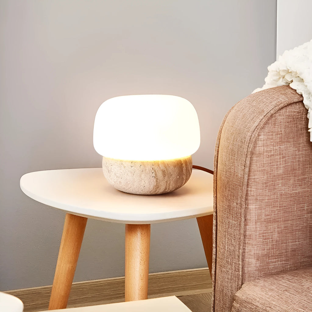 Cream coloured retro ceramic bedside lamp with a globe fabric shade and button switch.