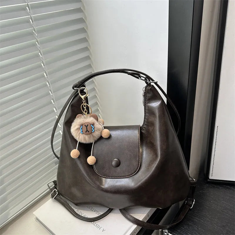Black leather PU women's single-shoulder backpack with textured finish and horizontal square shape