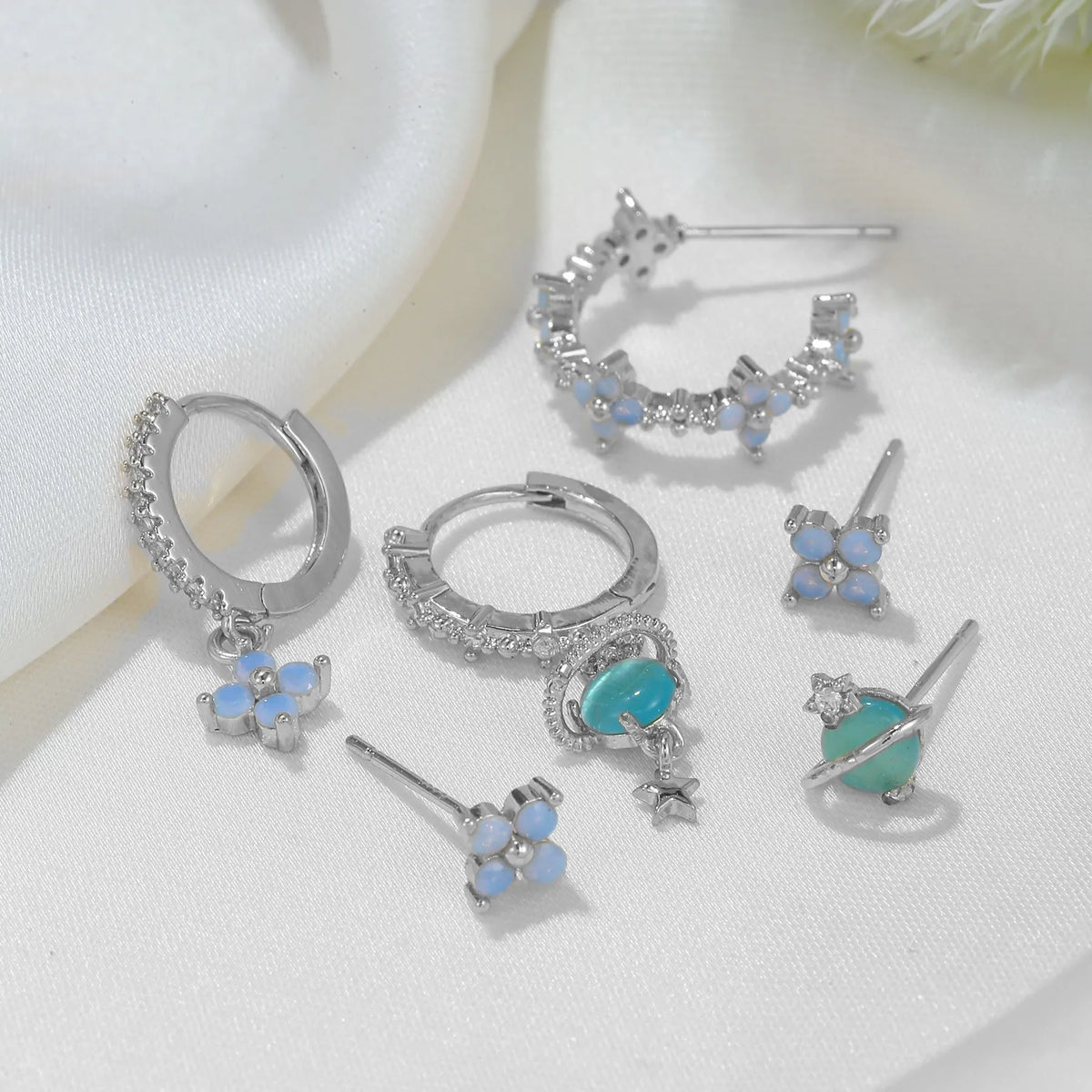 Gold and silver Japanese Korean style flower ear studs with blue flower nail and zircon mosaic design.