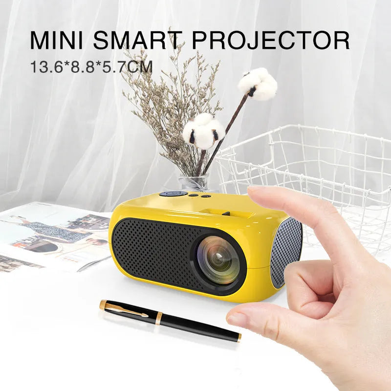 M24 gold micro mini projector with power adapter and AV cable on white background