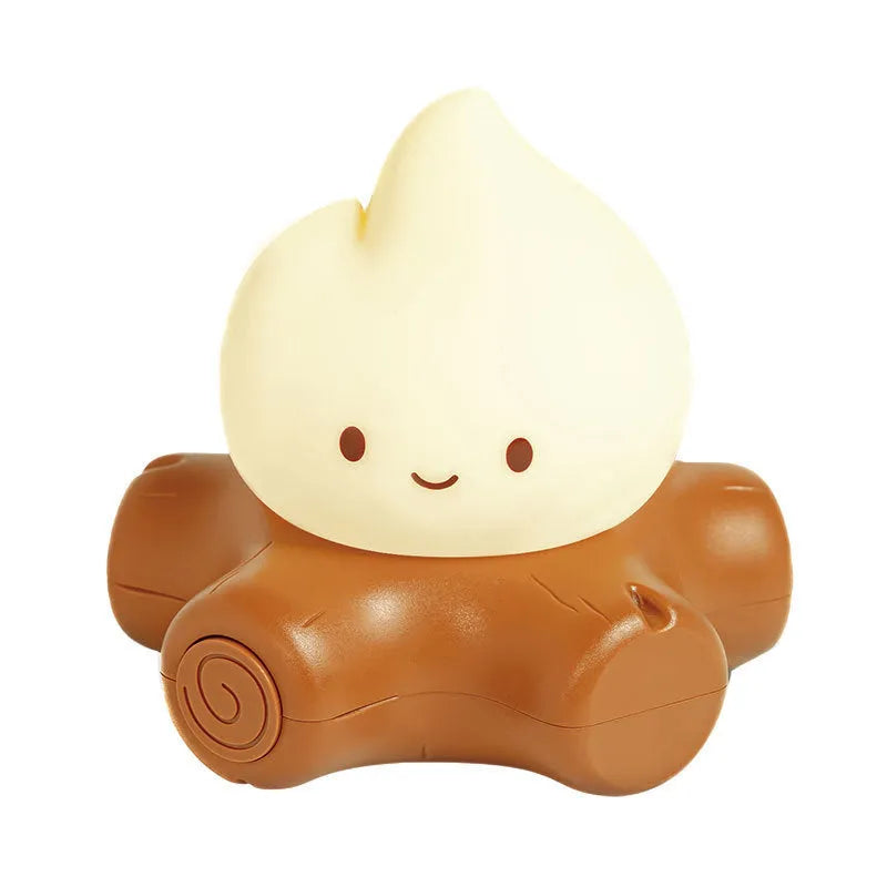 Small cartoon silicone fire pile night lamp with yellow glow on a surface