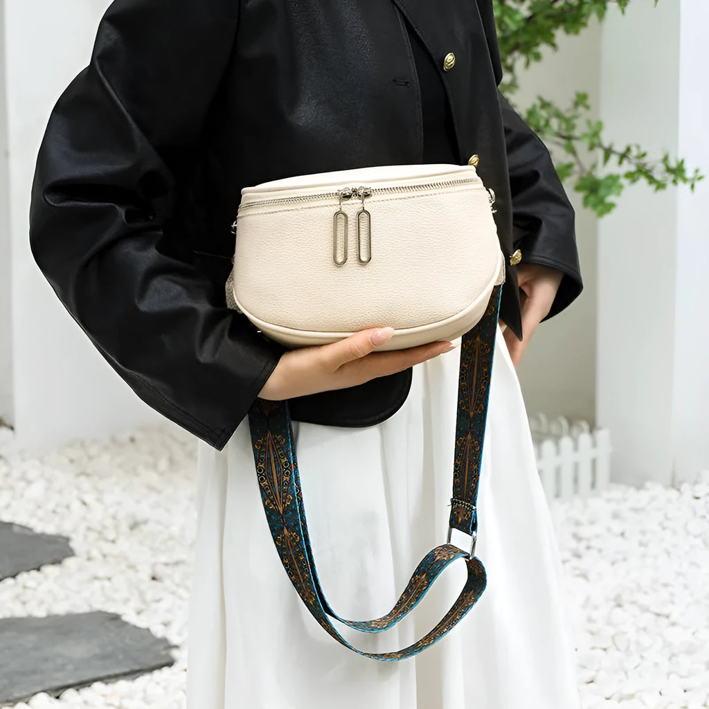 Women's soft PU leather messenger bag in saddle shape with cross-body strap and zipper pocket.