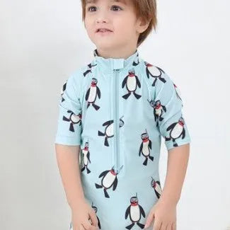 Boys' penguin print long sleeve swim shirt and matching swim cap set.
