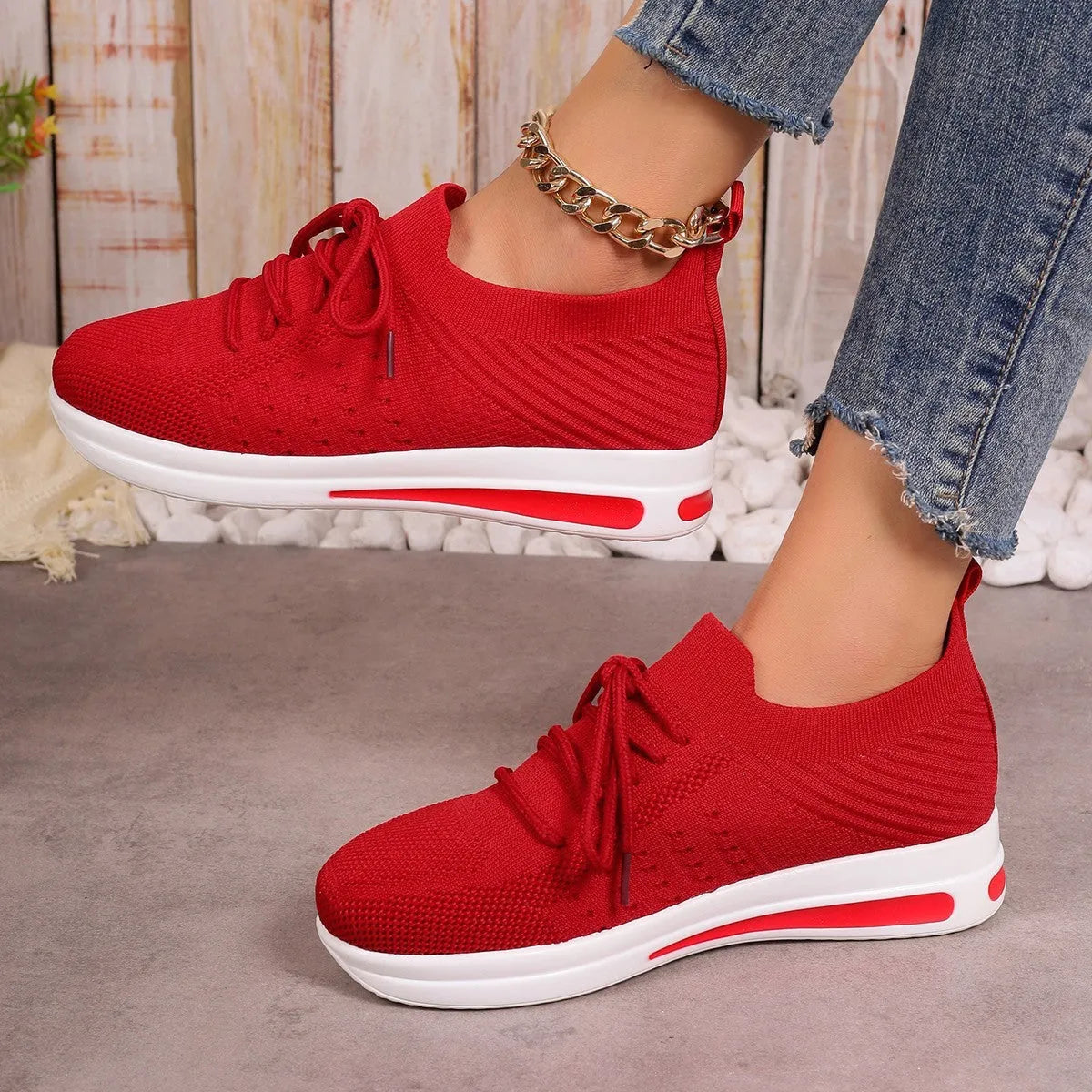 Women's black fly-knit casual sneakers with lace-up front and low-top design on a white background.
