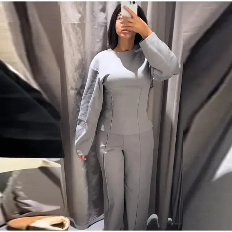 Women's black polar fleece long sleeve pleated top and wide leg trousers suit set.