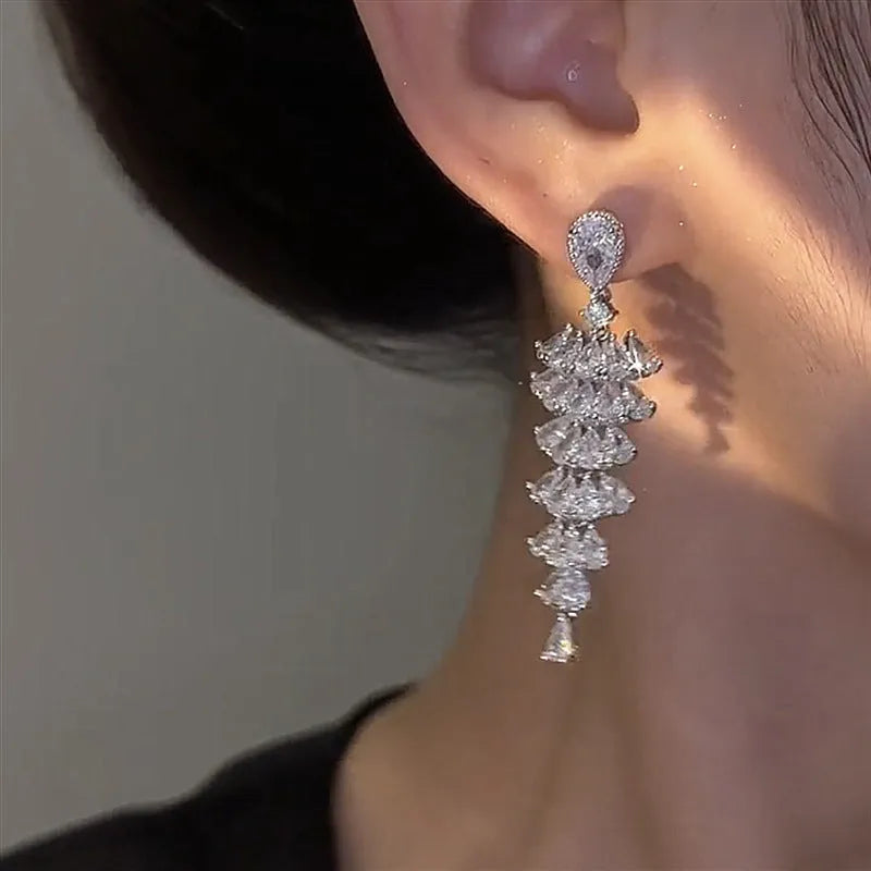 Silver Pagoda colour Christmas tree shaped drop earrings with stud fastenings and sparkling zircon finish.