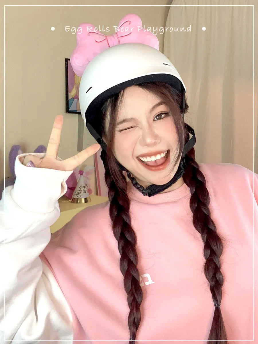 Soft plush bow helmet decoration with pom-pom in red, pink, and peach colour options.