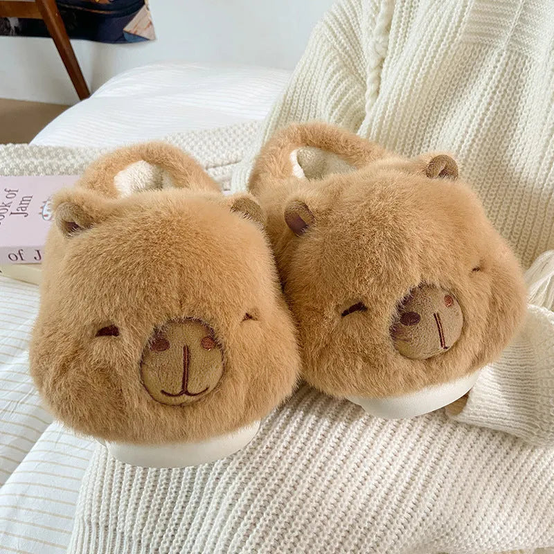 Light brown women's winter plush slippers with a cartoon pattern and artificial wool lining.