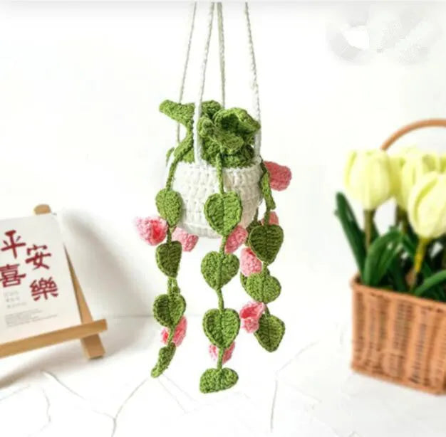 Green and white knitted car plant ornament with basin base and hanging rope