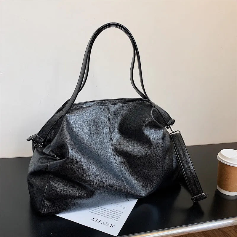 Large soft-surface PU leather messenger tote bag with long crossbody strap, shown in black colour