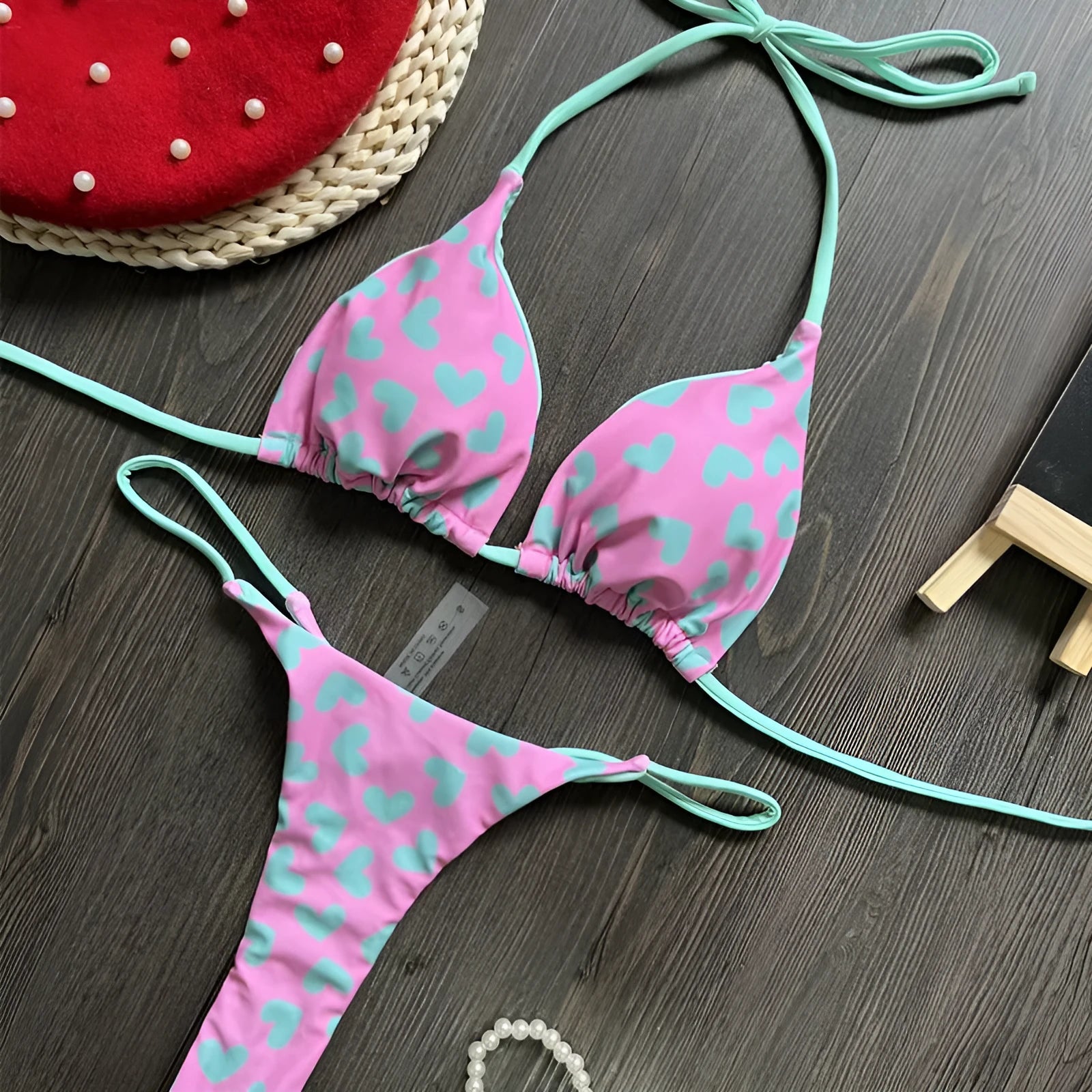 Heart print backless one-piece swimsuit with high side splits on a model