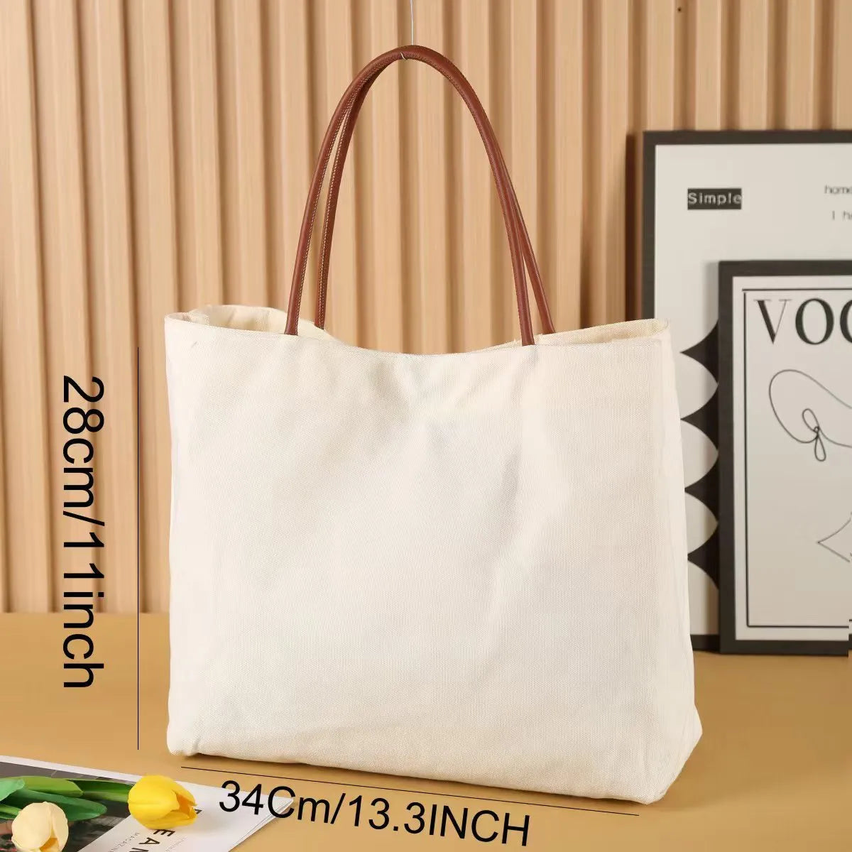 Beige white and white canvas tote bag with long handle straps.