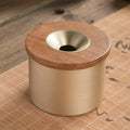 Retro solid copper ashtray with a wooden lid showing the centre hole.