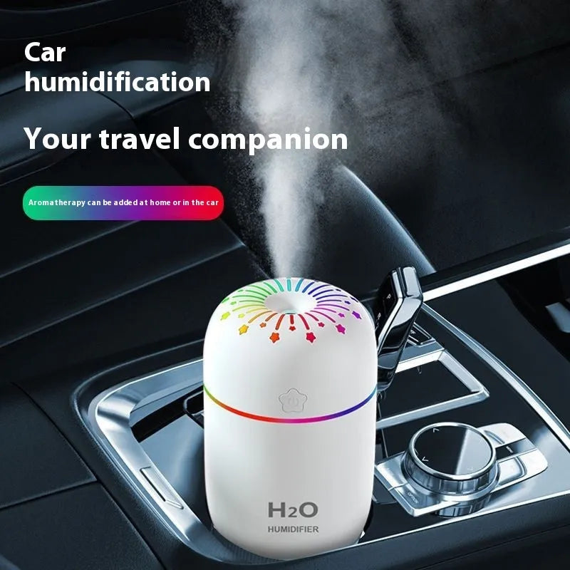 Fireworks A5 white USB mini humidifier on a desk next to a laptop