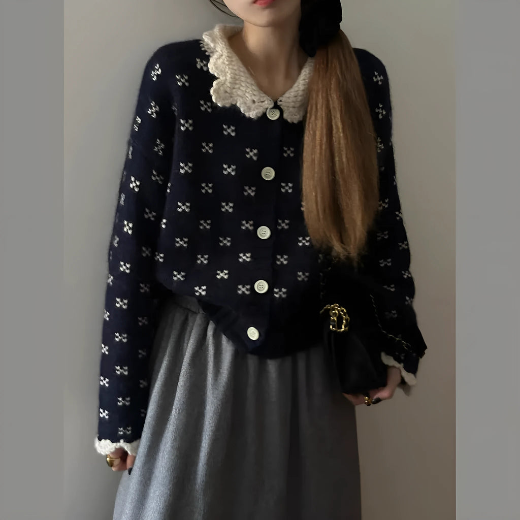 Navy blue floral patterned knitted cardigan coat with a white Peter Pan collar and button front.