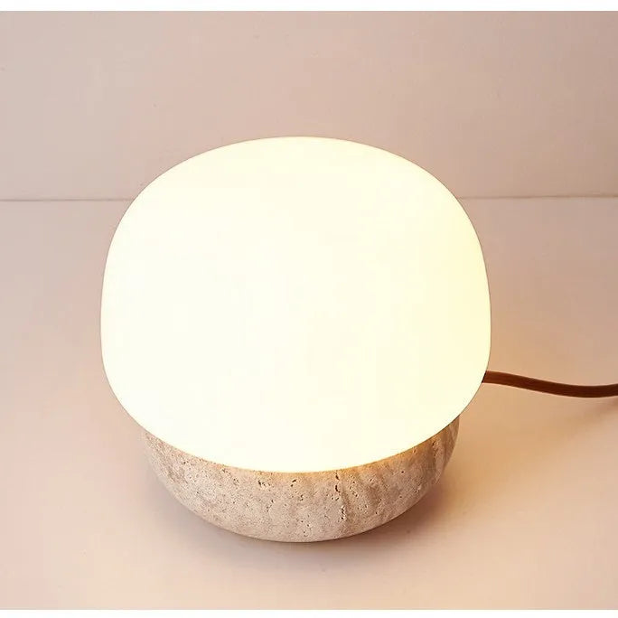 Cream coloured retro ceramic bedside lamp with a globe fabric shade and button switch.