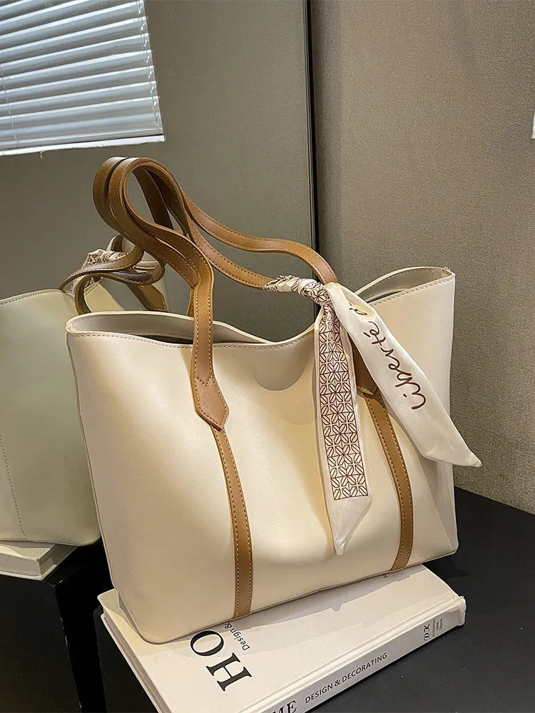 Women's casual tote bag with bucket design showing shoulder strap and crossbody carrying option