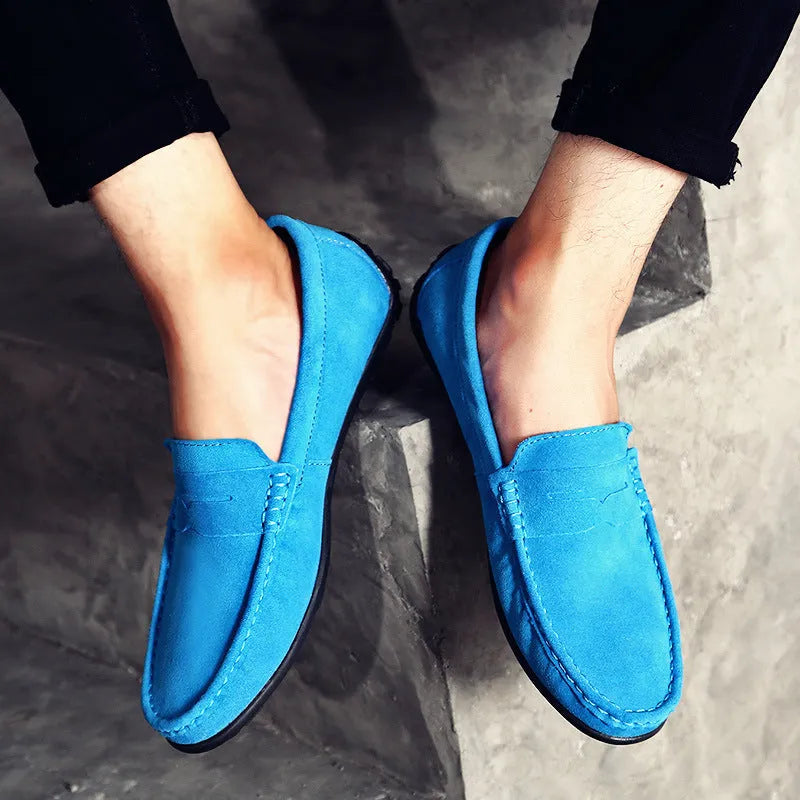 Men's brown suede Gommino casual shoes with round toe and flat rubber sole on a white background