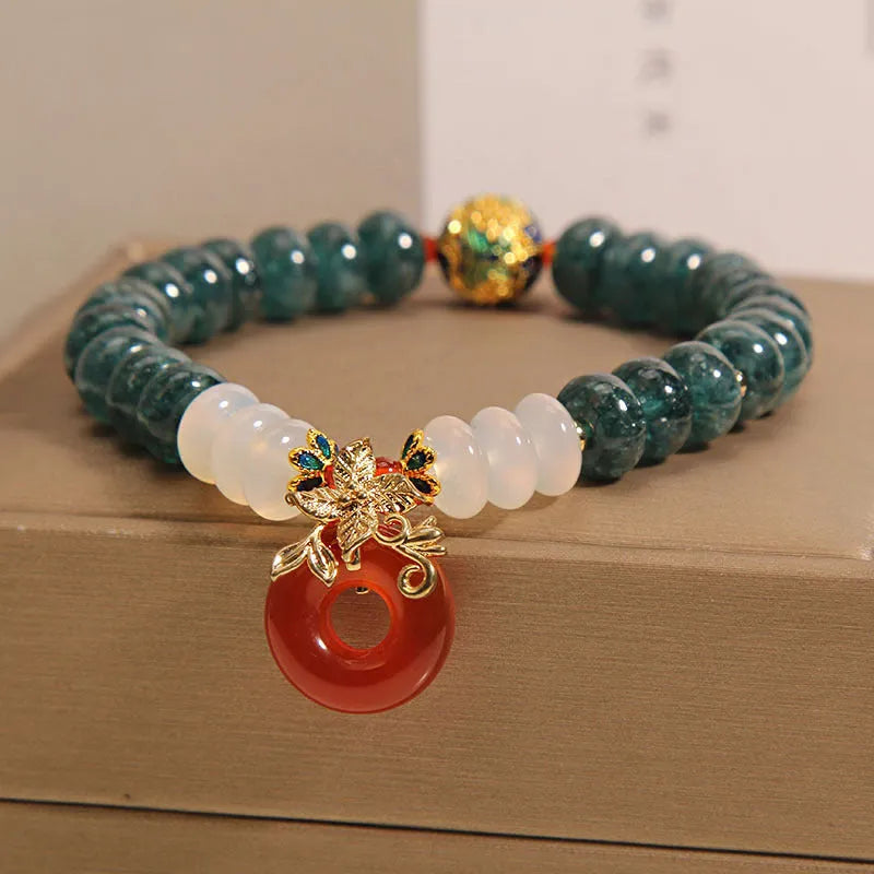 Women's blue water jade and red agate bracelet with peace buckle closure and rhinestone details