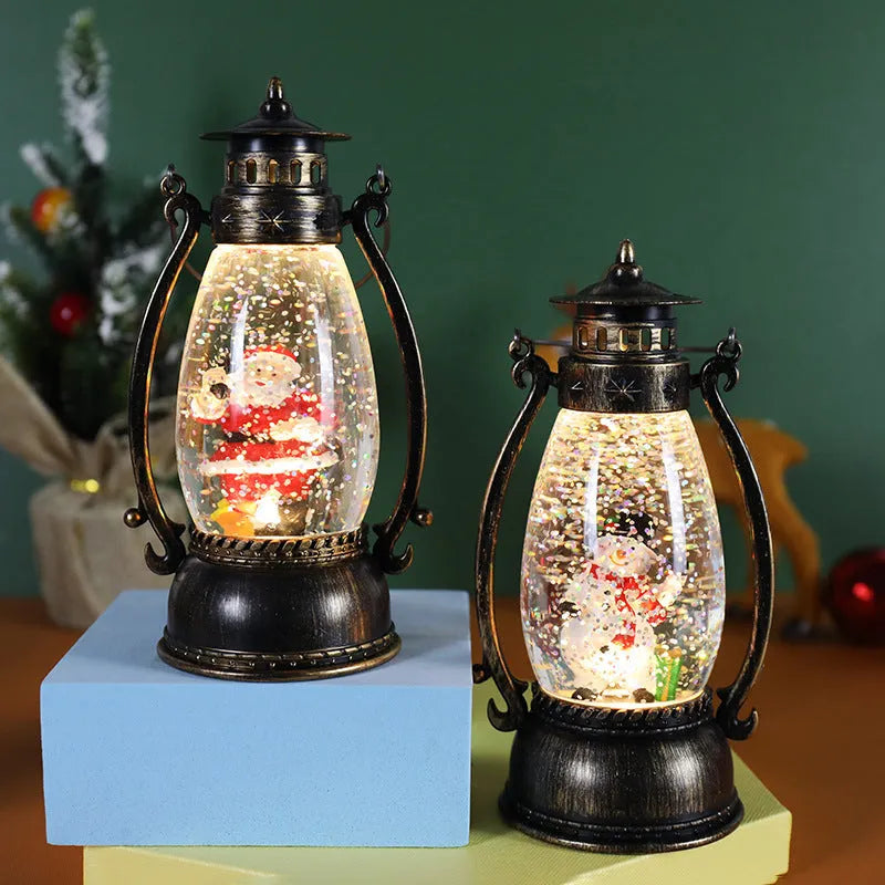 Clear plastic crystal ball oil lamp with LED light, showing snowman and elderly figure design options.