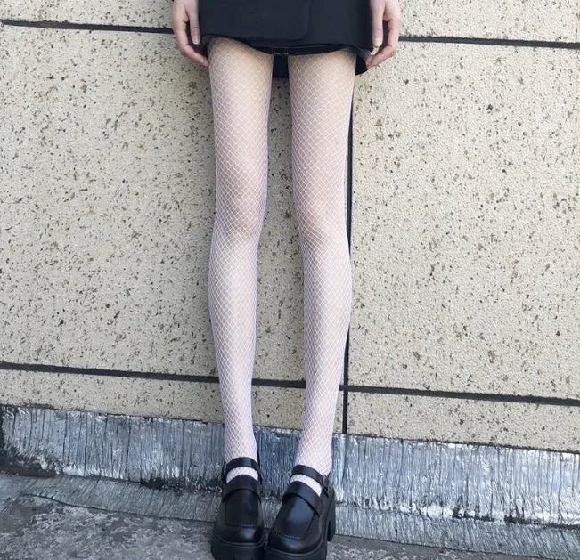 Women's black and white mesh stockings showing large, medium, and small net patterns on a leg.