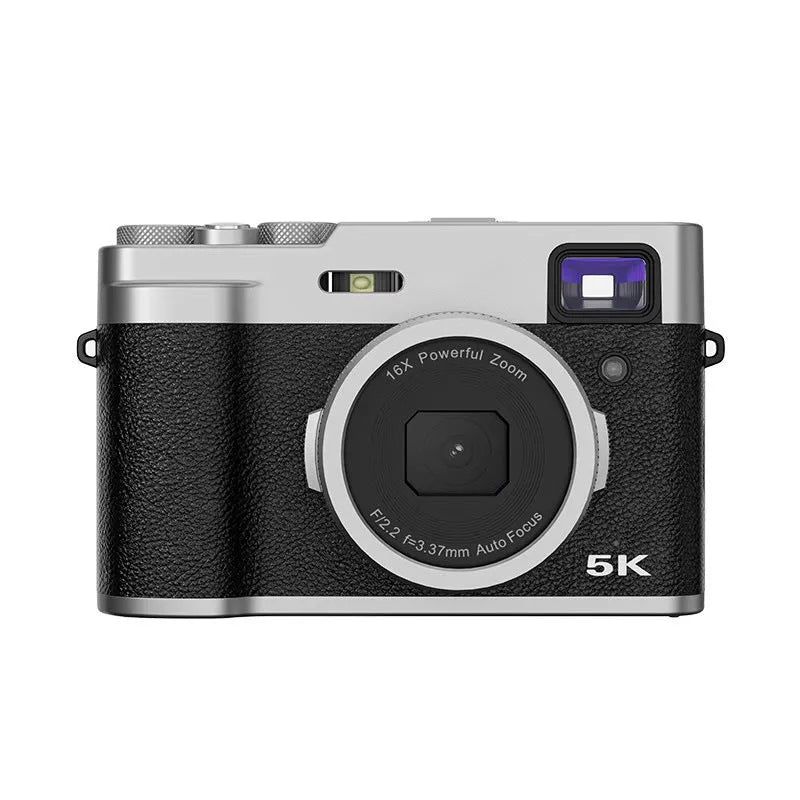 Black 5K HD digital camera with dual lenses and an optical viewfinder on a table with its accessories.