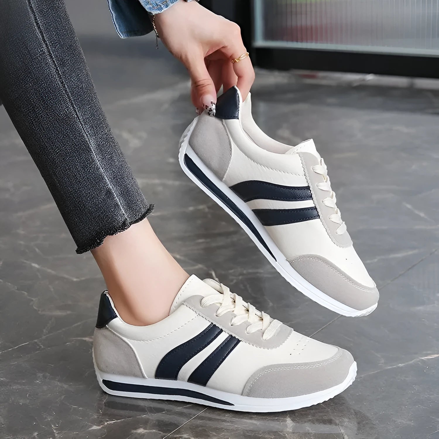 A pair of low-top red and blue lace-up running sneakers with a PU mesh upper and rubber sole on a white background.