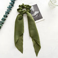 Spring dark green floral cloth ribbon hair tie formed into a large intestine ring shape.