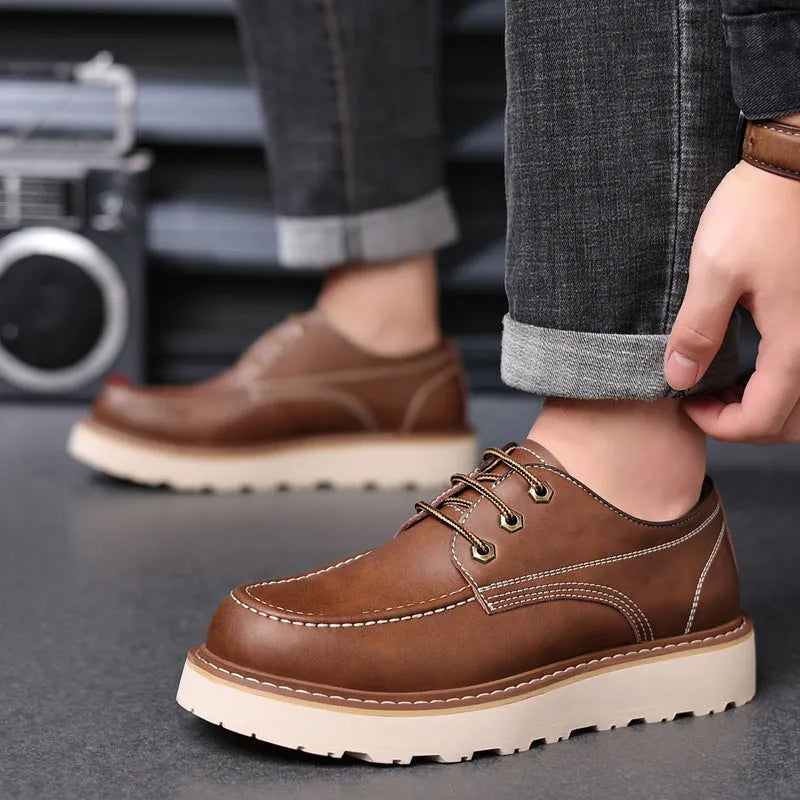 Men's black low top Martin boots with round toe and non-slip rubber sole on a neutral background.