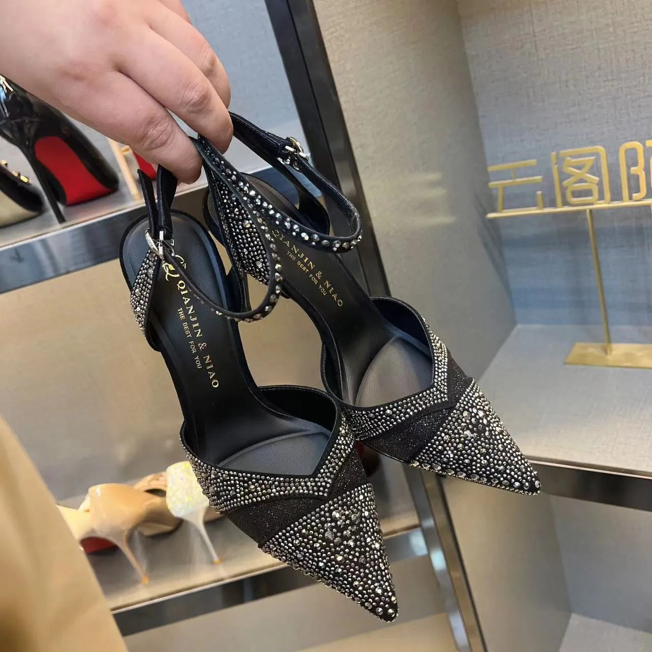 Women's black hollow high heels with red sole and pointed toe stiletto design
