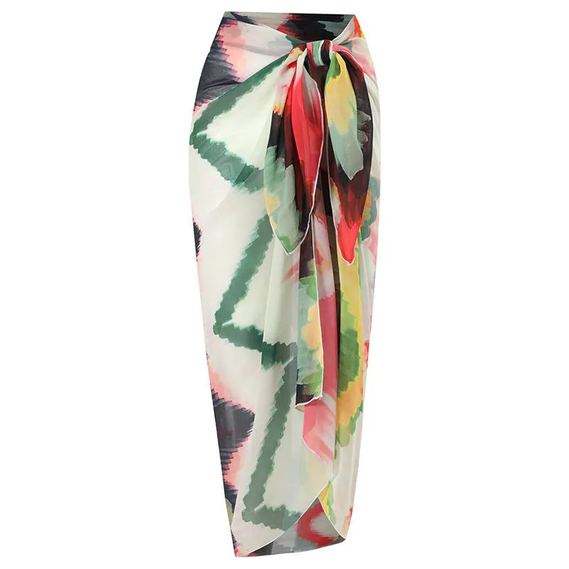 Women's two-piece striped swimsuit with a matching gradient print hip skirt laid flat.