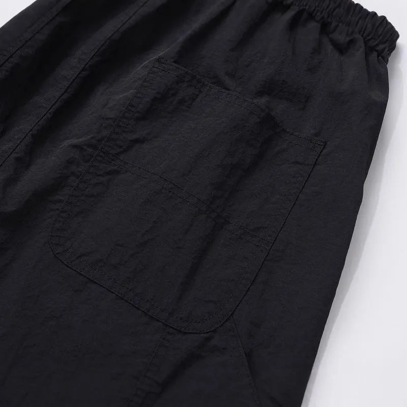 Black baggy paratrooper trousers with elastic drawstring waist and three-dimensional cutting