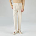 Men's straight-leg loose fit corduroy trousers in beige shown on a model.