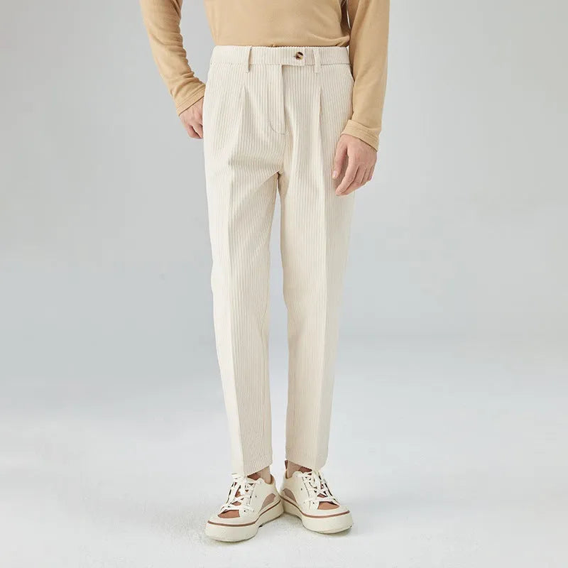 Men's straight-leg loose fit corduroy trousers in beige shown on a model.