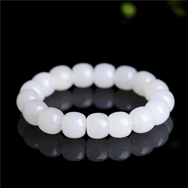 White Hetian jade barrel bead bracelet on a wrist, showing three bead size options.