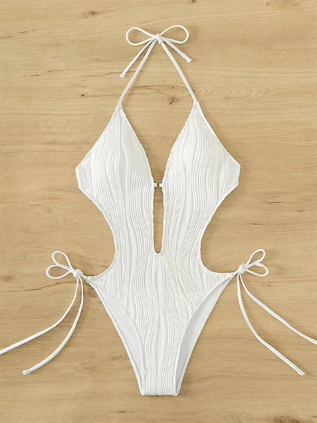 Women's black triangle bikini with adjustable front lace-up detail, shown on a mannequin.