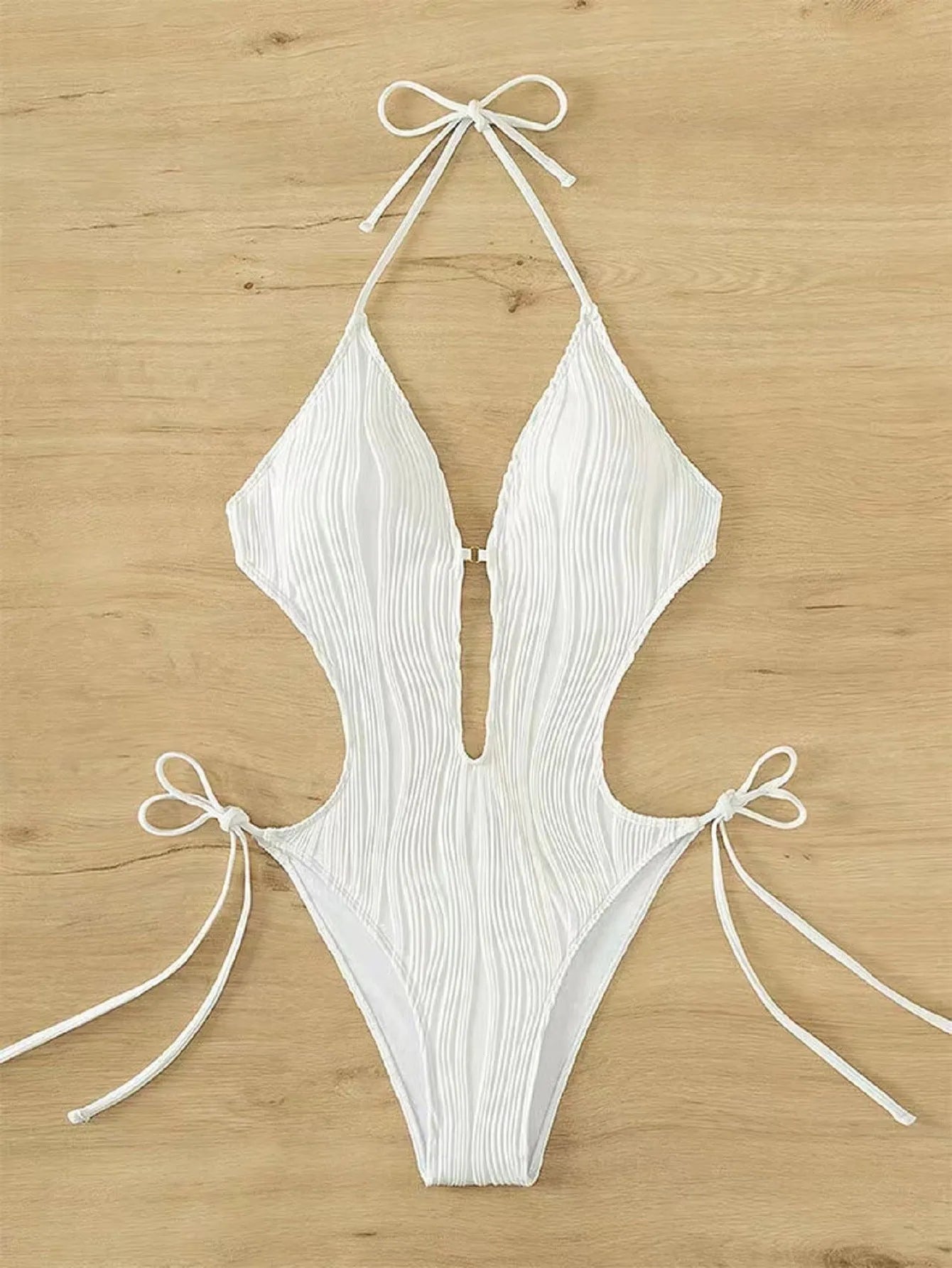 Women's black triangle bikini with adjustable front lace-up detail, shown on a mannequin.